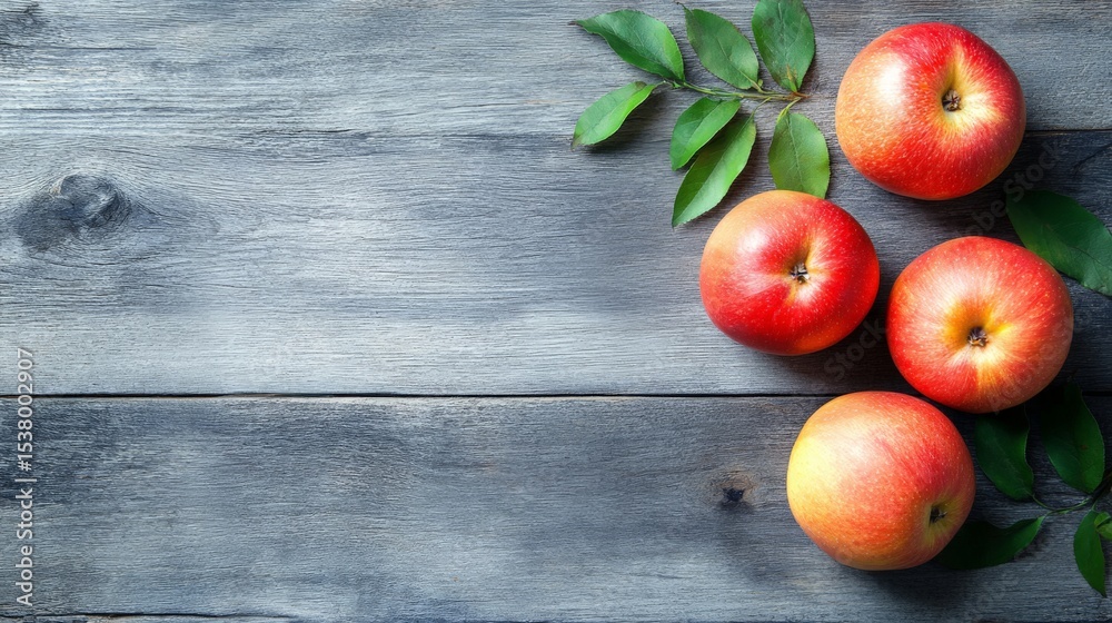 Ripe red apples arranged on rustic wooden surface Ripe red apples arranged on rustic wooden surface