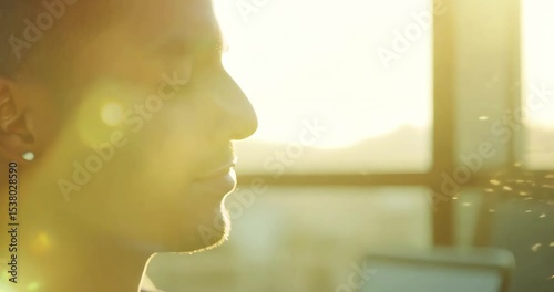 Business person sitting at a desk with eyes closed, hands resting on the table, calmly breathing, morning sunlight through the window