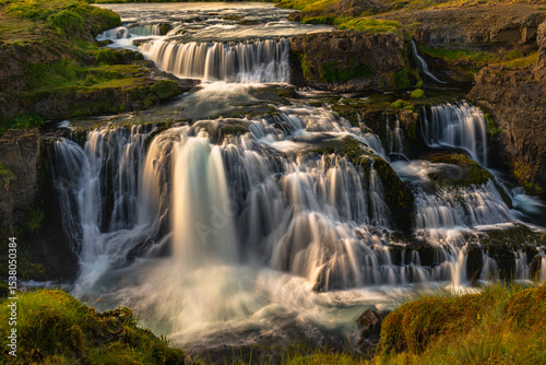 Golden light on Reykjafoss waterfall in Iceland photo