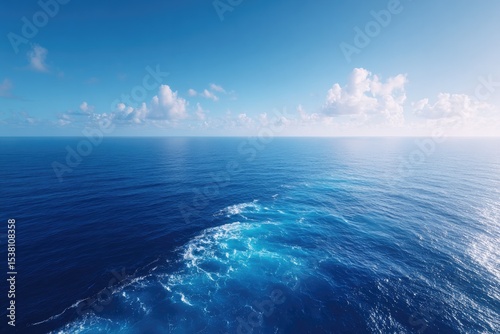 capture expansive shimmering surface of ocean from drone-shot aerial view embracing vastness and depth below