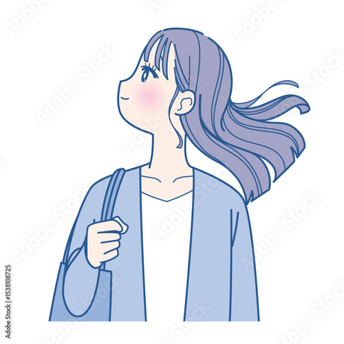 髪をなびかせる若い女性