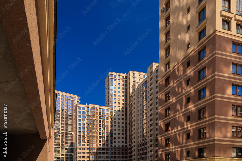 Fototapeta premium City view on a sunny day. Modern houses against the blue sky.