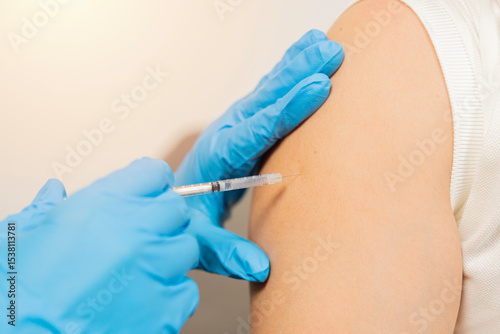 Close up of nurse hands getting vaccinated with syringe and needle.