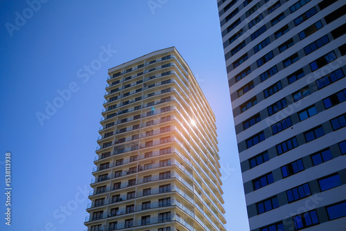 Cityscape on a sunny day. Modern building against the blue sky.