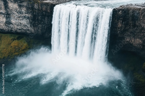 Majestic waterfall cascading down rocky cliff nature landscape scenic view tranquil environment captivating concept