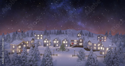 Glowing string-lit houses and wood fence framing decorated tree in village night, falling snowfall