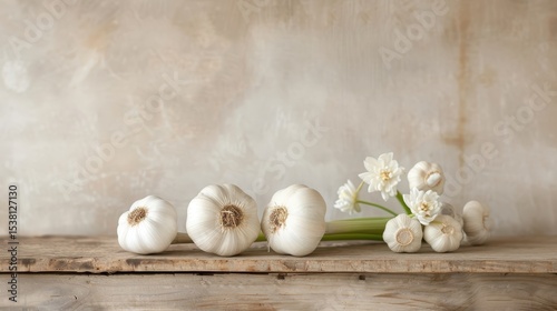A still life of garlic bulbs with their papery skins peeling back.