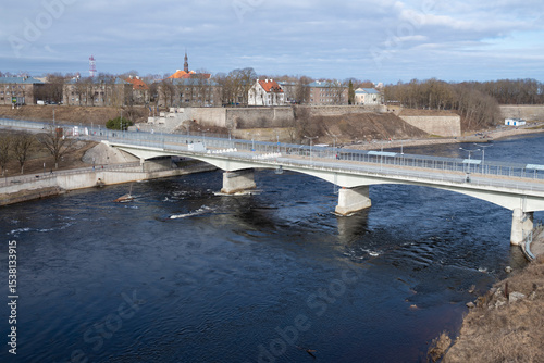 View of the Friendship Bridge border crossing and the city of Narva from the Russian side on a March day. Estonia-Russia border