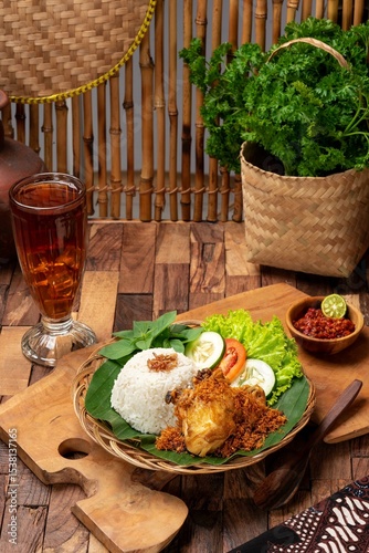 Nasi ayam rempah is a dish made with fragrant jasmine rice and spicy chicken, while nasi kari ayam features creamy curry chicken. Both are must-tries for any food lover. photo