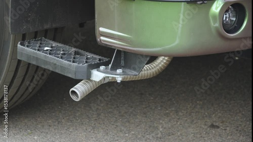 Exhaust pipe of truck with blue smoke coming out of it. Harmful emissions and crankcase gas removal in design of tractor. Environmental standards for motor transport and air pollution.