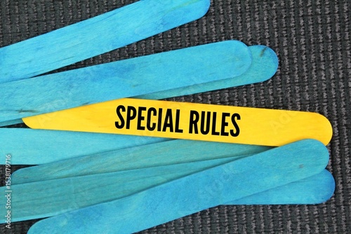 Colored wooden sticks with the text special rules. specific rule that only applies to a particular situation or circumstance.