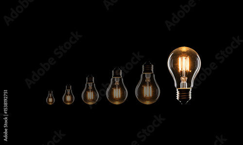 Electric incandescent lamp shines in the dark. Idea. Many light bulbs