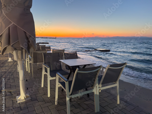 Fototapeta Naklejka Na Ścianę i Meble -  Restaurant on the beach on Chalkidiki island at sunset in Greece