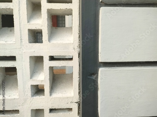 Concrete ventilation blocks and modern cement wall in geometric pattern. Urban architectural texture with repetitive shapes and lines. Minimalist construction detail.