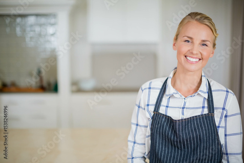 Wooden counter running through home kitchen with subway-tile backsplash and utensils, copy space