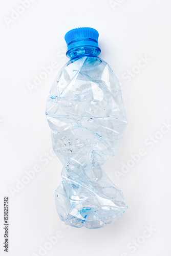 Crumpled empty plastic bottle on a white background
