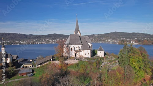 Flight over of Maria Worth church on Lake Worthersee, in Carinthia, Austria.