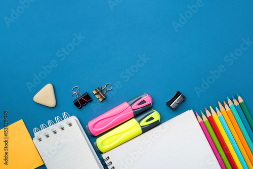 Bright school supplies on a blue background. The back to school concept