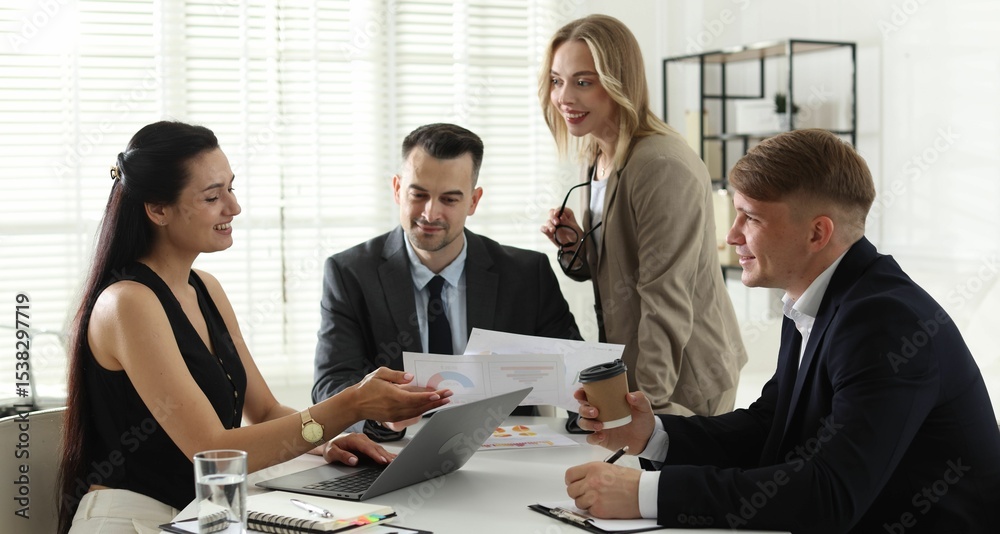 Marketing. Team of businesspeople working together at desk in office Marketing. Team of businesspeople working together at desk in office