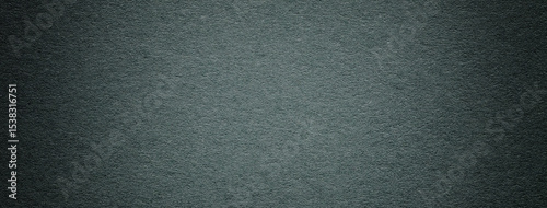 Old dark green textured paper background with vignette effect and natural surface, macro. Structure backdrop