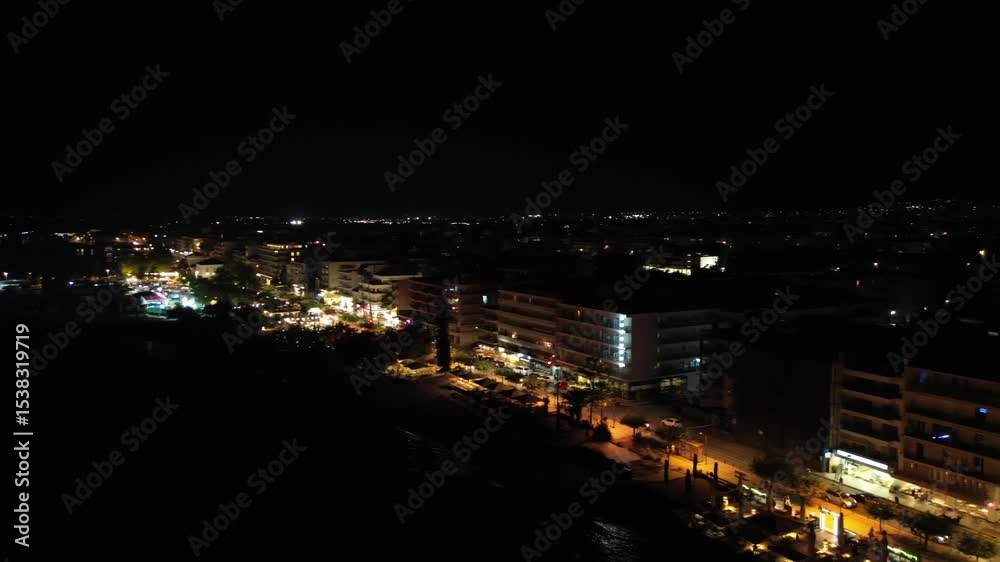 Aerial, night cityscape of Kalamata city, lights on Navarinou street coastal road and Iroon street at eastern suburbs of the city, slow right pan establishing shot 4K Aerial, night cityscape of Kalamata city, lights on Navarinou street coastal road and Iroon street at eastern suburbs of the city, slow right pan establishing shot 4K