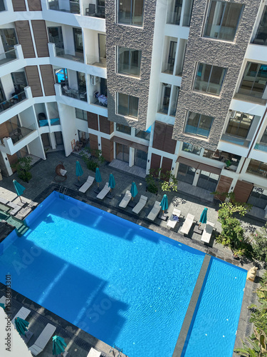 view of the courtyard of the apartment with pool and relaxation area, vacation, comfort. High quality photo