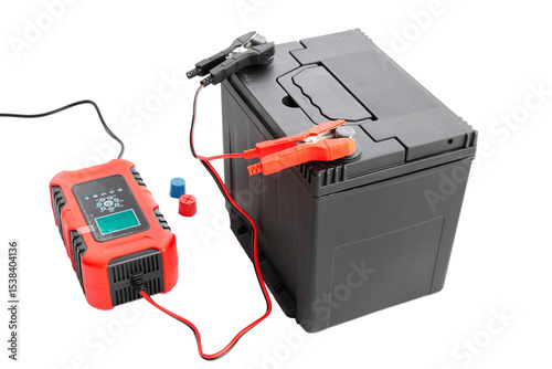 recharging AGM car battery with automatic charger, cut out, isolated background. Battery restoration and care concept. photo