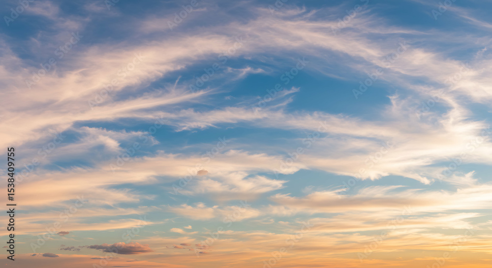Fototapeta premium Dramatic clouds painted with soft colors during twilight sky create a dreamy atmosphere