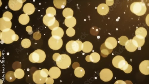 Golden bokeh light circles and flickering particles moving across a dark background, abstract festive texture video footage.