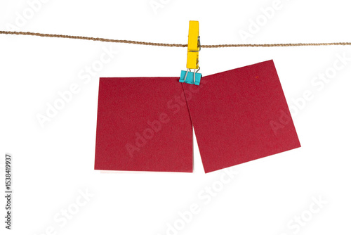 Two pieces of red rectangle paper hang on a rope
