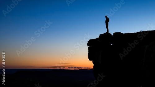 Solitary person standing on cliff edge at sunset, silhouetted against open sky, symbolizing inner struggle and despair. Emotional concept of isolation and personal challenges.
