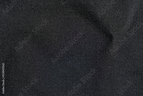 Fabric composed of wool and polyester, macro texture, abstract black fabric background.