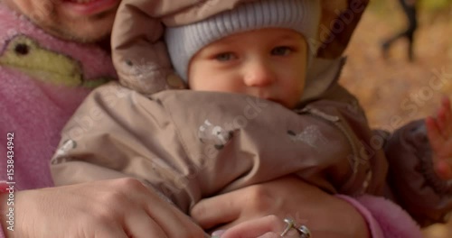 A closeup shot beautifully showcases an adult gently holding a childs small hand, highlighting the profound connection and bond they share amidst a serene and picturesque outdoor setting