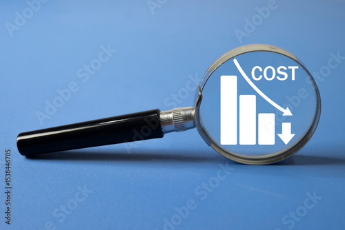 Magnifying glass focusing on a cost reduction chart. Concept for business expense management, budget optimization, financial savings,Price reduction,financial analysis,business and finance planning.