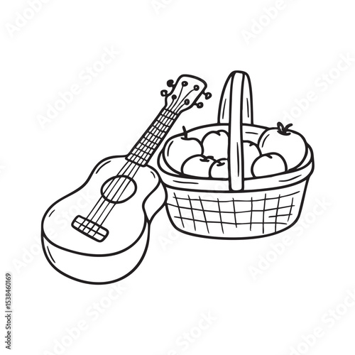 A ukulele lying beside a fruit filled picnic basket