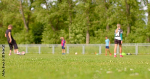 Young athletes practice soccer on a vibrant field, guided by knowledgeable coaches, focusing on teamwork and skill development to enhance their coordination and performance