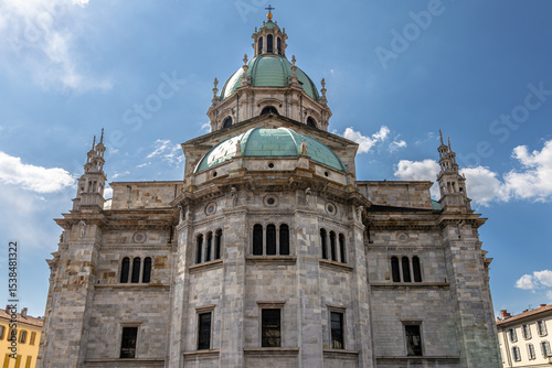 Historic Stone Cathedral with Green Dome and Cloudy Blue Sky Background