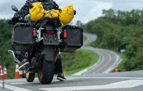 motorcycle on the road rides away. Travel on vacation, enjoy the nature trail. motorcycle in a sunny motorbike on the road riding.with sunset light. copyspace for your individual text.	