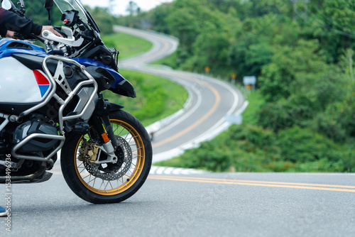 motorcycle on the road rides away. Travel on vacation, enjoy the nature trail. motorcycle in a sunny motorbike on the road riding.with sunset light. copyspace for your individual text.	