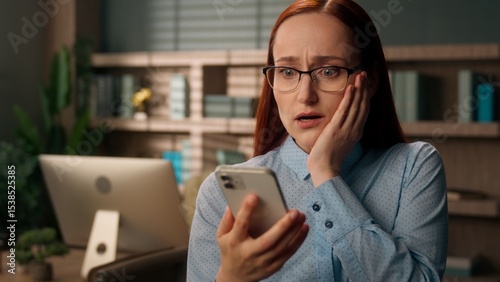 Stressed woman Caucasian girl upset frustrated businesswoman worker office holding mobile phone fail problem negative bad news worried sad trouble rejection message crash lose online shock credit debt