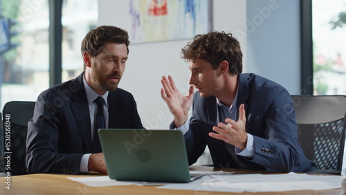 Businesspeople talking virtual meeting looking laptop in private room closeup