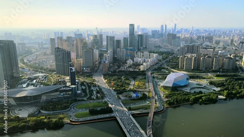 Prosperous shenyang city center financial district and hun river overlook during daylight hours, showing modern architecture and busy transportation