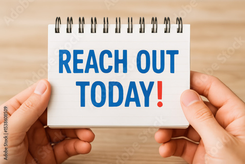 Motivation drives action as two hands present a notepad urging connection and initiative in a vibrant tone photo
