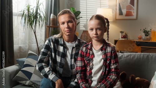 Caucasian family problem sad mother woman female mom babysitter offended with adorable custody adopt child kid girl daughter after conflict quarrel silence ignoring at home misunderstanding upset photo