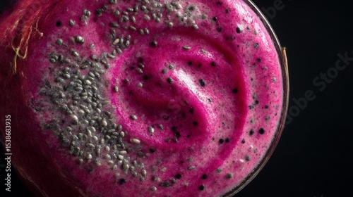 Vibrant pink smoothie topped with chia seeds in a glass, showcasing a creamy texture and rich color, perfect for healthy lifestyle and nutrition concepts