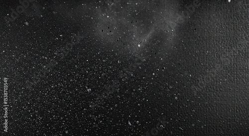 Close-up shot of water droplets on a dark surface creating an abstract texture