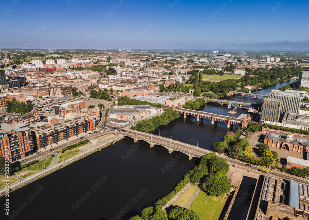 Fototapeta premium Glasgow Scotland: 18th May 2025: Drone photo of River Clyde bridges with City of Glasgow College exterior on sunny day nautical training facility