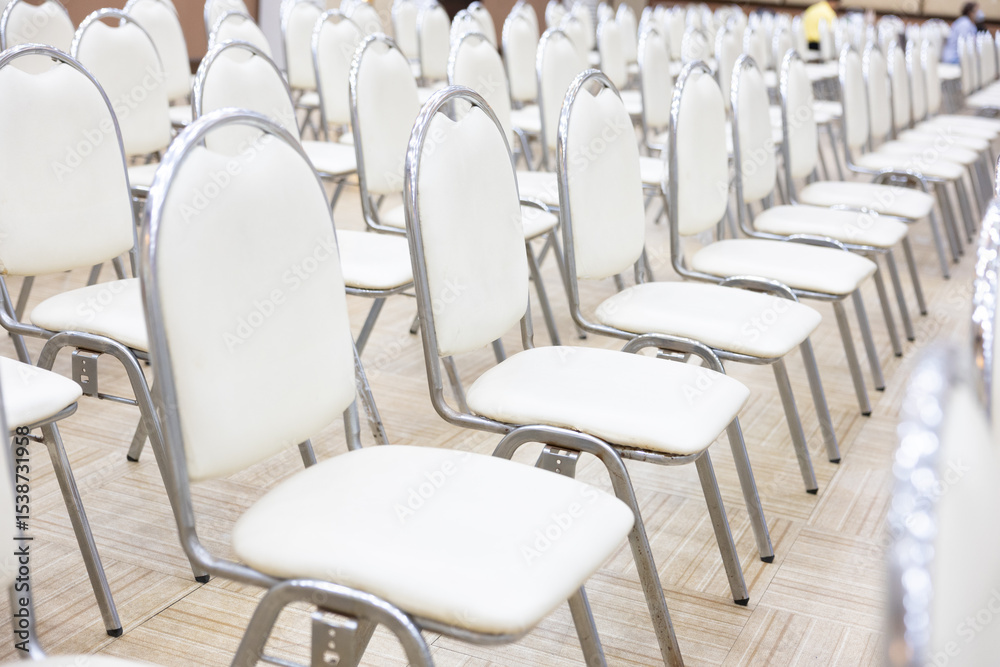 Fototapeta premium Rows of empty chairs arranged in school auditorium or assembly hall