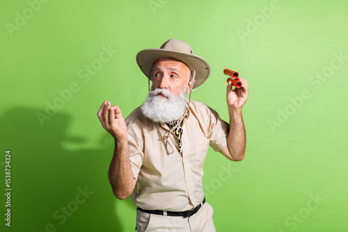 Photo of dissatisfied scientist naturalist senior man taste feel disgusted wear safari suit isolated green color background
