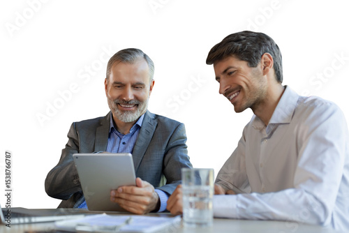 Mature businessman using a digital tablet to discuss information with a younger colleague on a transparent background